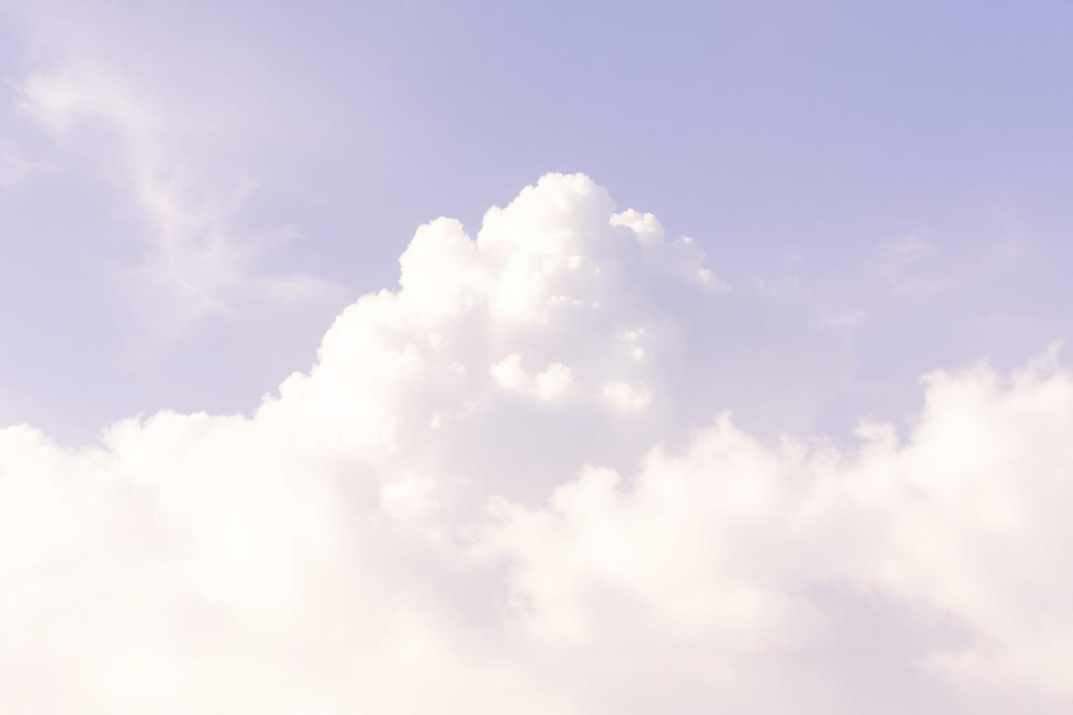 Soft lavender clouds drifting in pastel sky.